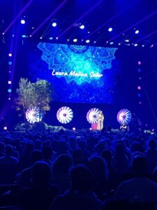 The stage covered in blue light with Laura Malina Seiler on it